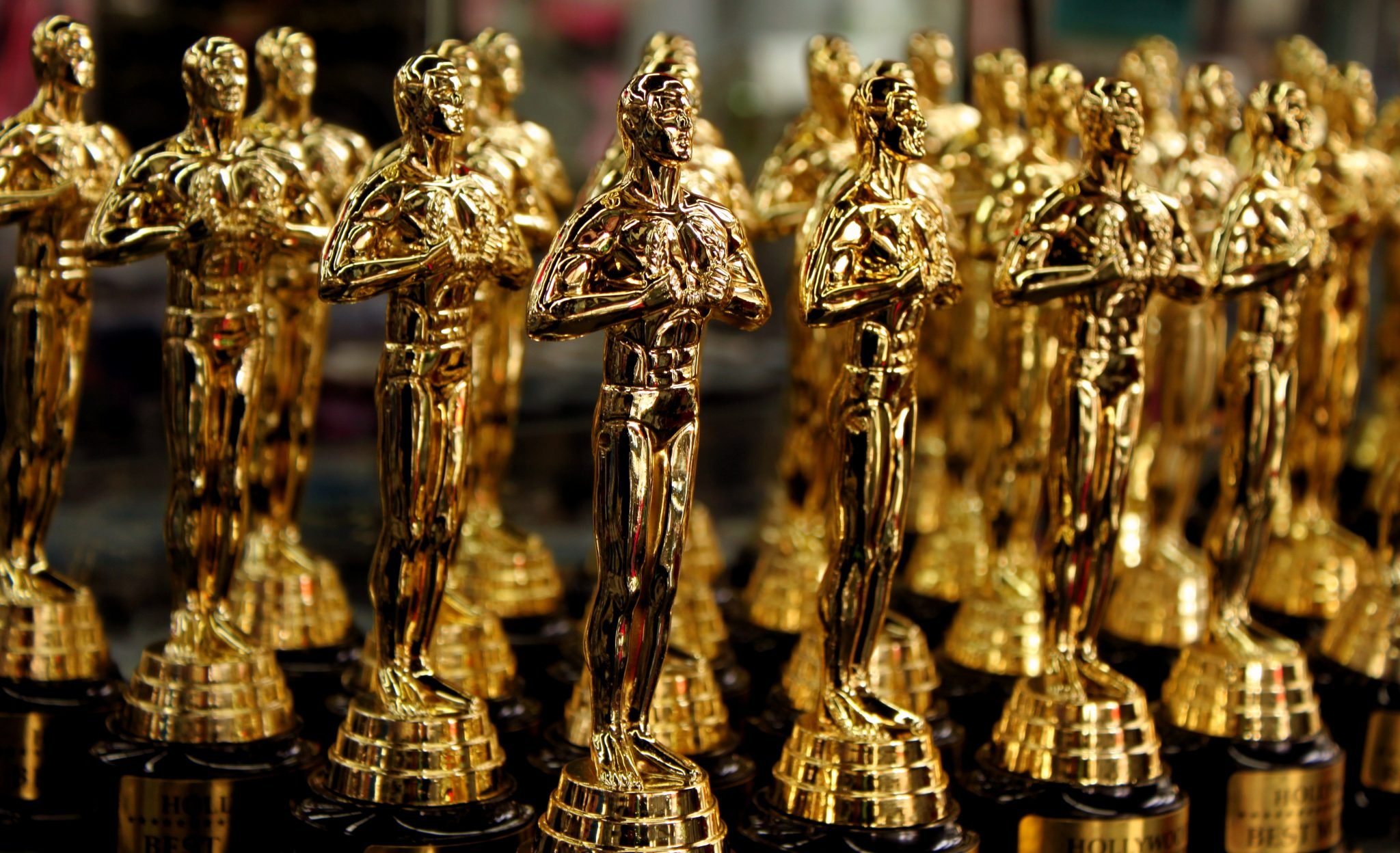 A series of gold Oscar statues on display.