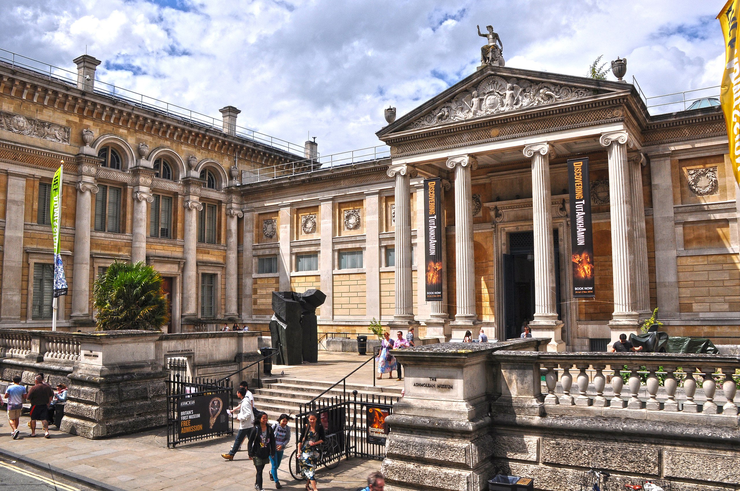 View of entrance of Ashmolean Museum on sunny day with a few clouds.