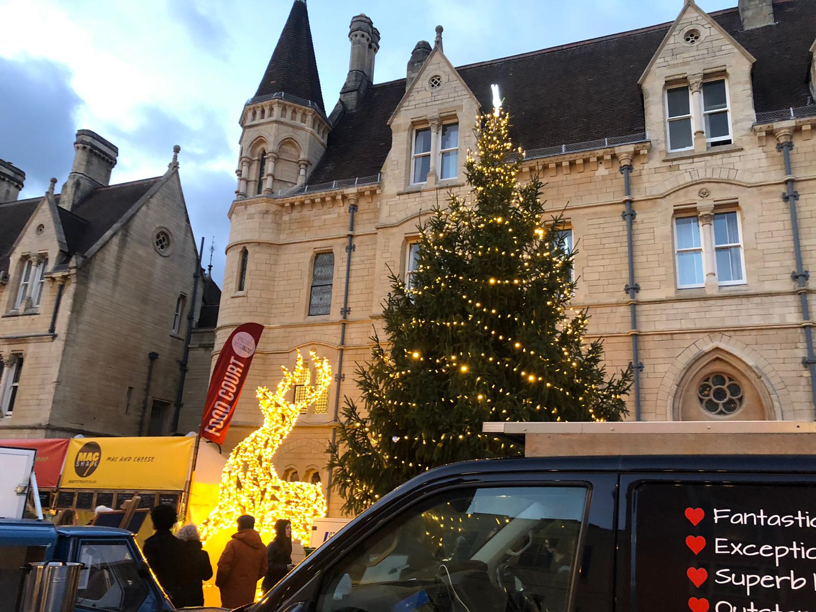 Balliol College with a large Christmas tree and reindeer sculpture.