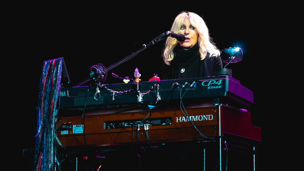 Chistine McVie singing and playing the keyboard