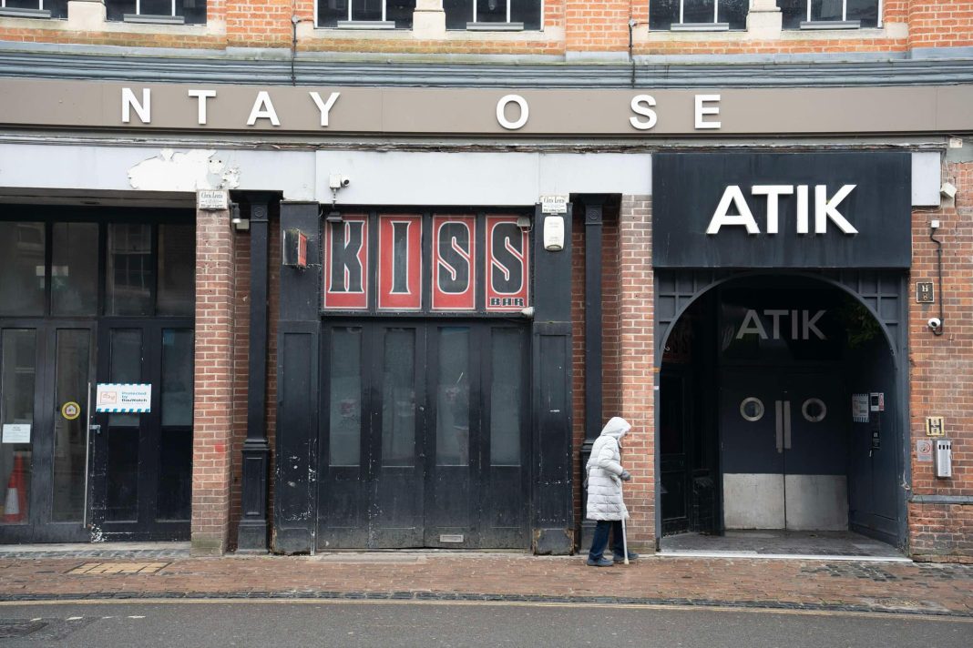 Kiss Bar and Atik under a Cantay House sign in disrepair