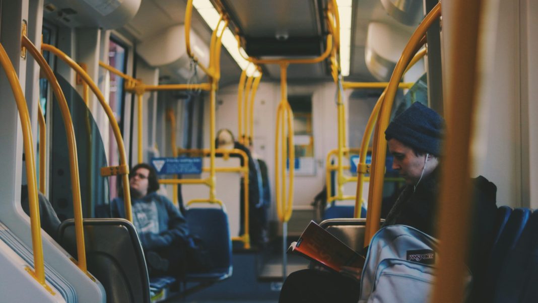 Man reading on a subway.